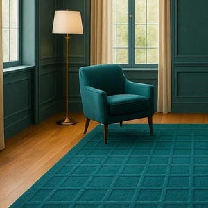 A luxury hand-tufted teal wool rug with a modern square grid pattern, placed in an elegant living room with teal armchairs, gold floor lamps, and large arched windows, creating a sophisticated and cozy atmosphere.