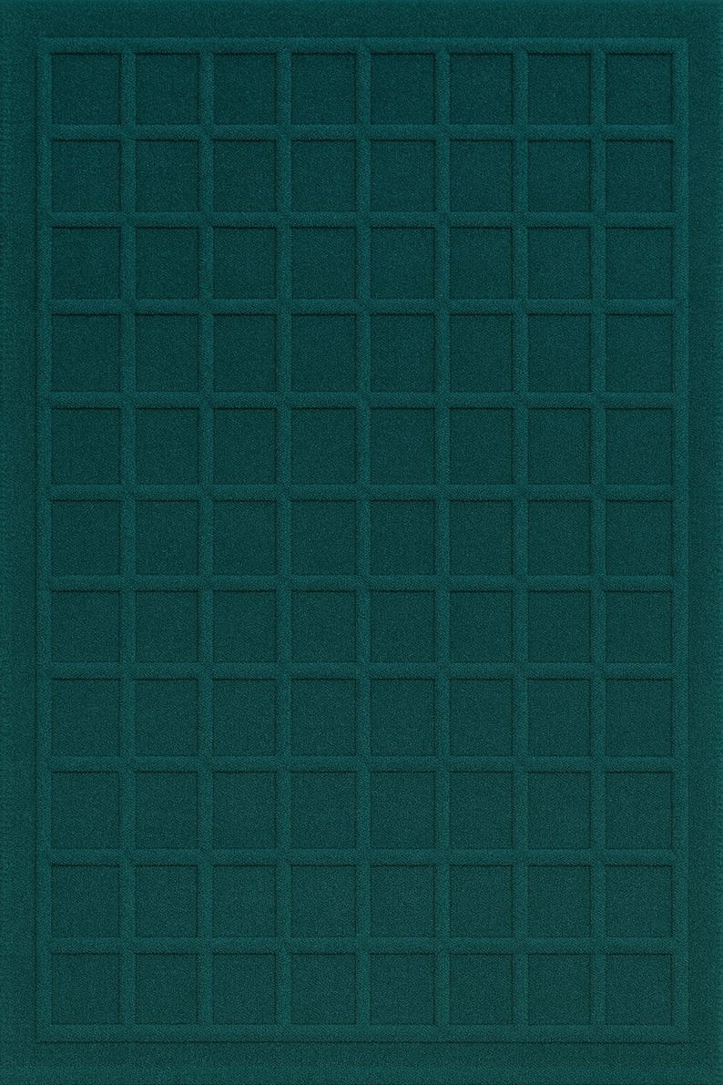 May include: Teal-colored rectangular rug with a grid pattern. The rug has a textured surface with a series of raised squares forming a symmetrical design. The edges of the rug are bordered.