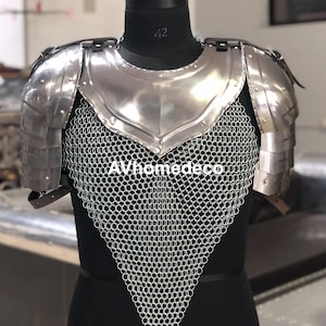 May include: A polished steel breastplate and shoulder armor with a chainmail lower section. The armor is displayed on a black mannequin. The text "AVhomedeco" is visible on the chainmail.