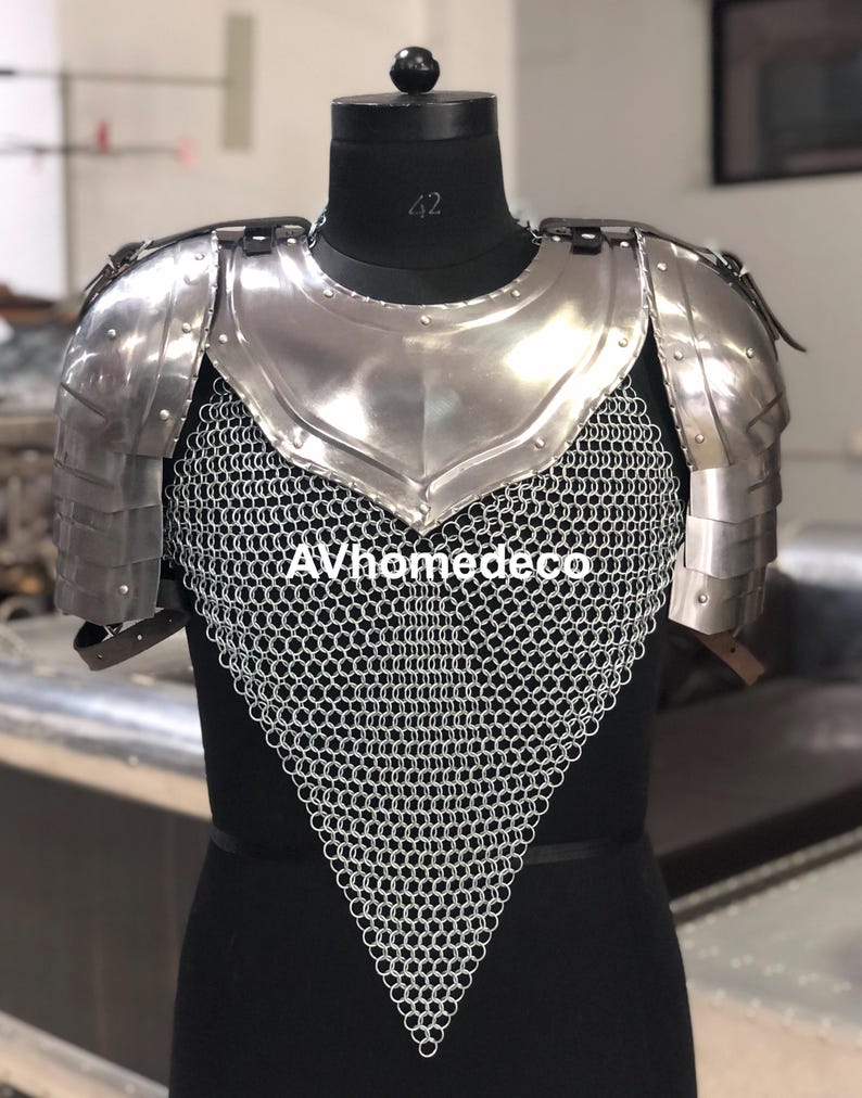 May include: A polished steel breastplate and shoulder armor with a chainmail lower section. The armor is displayed on a black mannequin. The text "AVhomedeco" is visible on the chainmail.