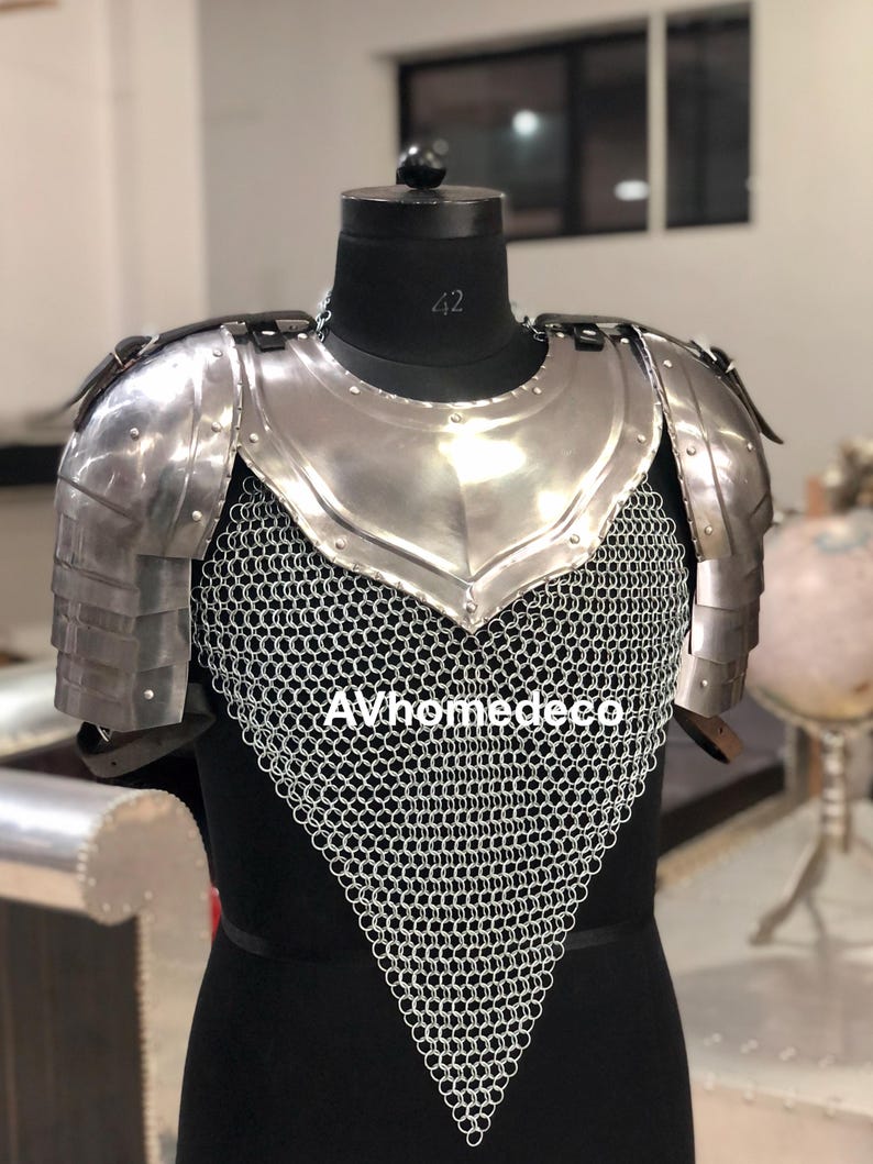 May include: A silver-colored medieval-style chest and shoulder armor set. The armor features a polished metal breastplate, shoulder guards, and chainmail. The text "AVhomedeco" is visible on the chainmail.