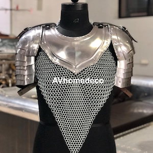 May include: A polished steel breastplate and shoulder armor set with chainmail. The armor is displayed on a black mannequin. The text "AVhomedeco" is visible at the bottom of the image. The armor is designed for historical reenactment or display.