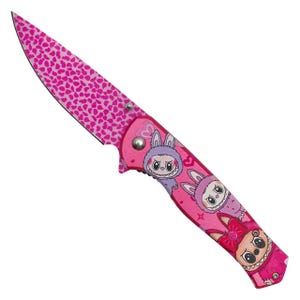 May include: A pink folding knife with a blade covered in small heart shapes. The handle features cartoon characters in bunny costumes. The knife is a vibrant pink color, with a silver rivet.