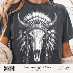 May include: Dark gray t-shirt featuring a detailed black and white graphic of a bull skull adorned with a Native American headdress. The design includes feathers, horns, and intricate patterns. The shirt has the text "Premium Digital Files" and "Studio Sonder Supply".
