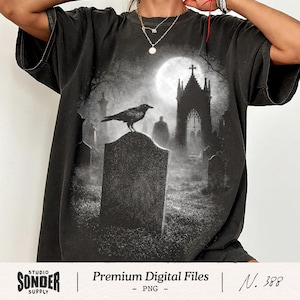 May include: Black t-shirt featuring a gothic graveyard scene with a crow perched on a tombstone under a full moon. The shirt has the text "Premium Digital Files" and "N. 388" printed on the bottom.
