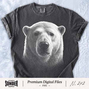 May include: Dark grey t-shirt with a black and white polar bear face print. The shirt has rolled sleeves and a crew neck. The text "Premium Digital Files" and "N. 242" are printed on the bottom of the shirt.