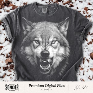 May include: Dark gray t-shirt featuring a detailed, black and white illustration of a snarling wolf's face. The wolf's teeth are bared, and its eyes are intense. The shirt has rolled-up sleeves and the text "Premium Digital Files - PNG - N. 121".