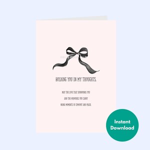May include: A sympathy card with a black bow illustration and the text "HOLDING YOU IN MY THOUGHTS." The card has a light pink background and includes additional text about comfort and peace. A green circle with "Instant Download" is in the bottom right.