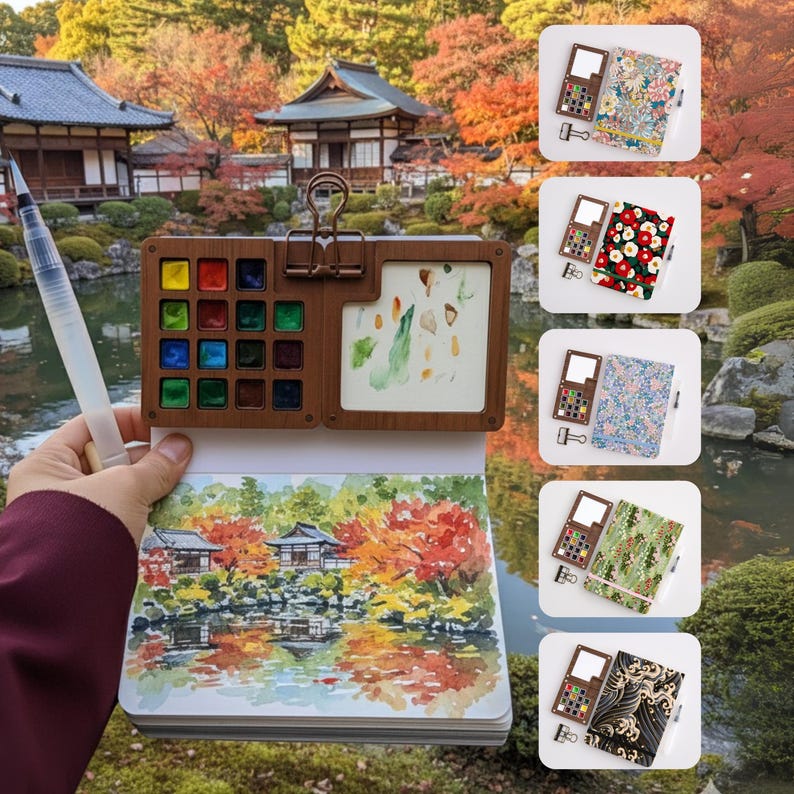 May include: A wooden watercolor palette and sketchbook set. The palette holds various colors of paint and a mixing area. The sketchbook features a watercolor painting of a Japanese garden with autumn foliage. Additional notebooks with floral and patterned covers are also shown.