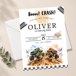 May include: A white invitation card with the text "Boom! CRASH!" and "OLIVER is turning three." Features watercolor illustrations of monster trucks and a checkered flag border. Includes date, time, and address details.