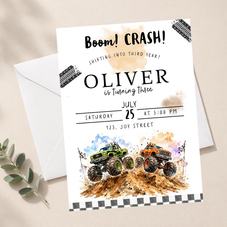 May include: A white invitation card with the text "Boom! CRASH!" and "OLIVER is turning three." Features watercolor illustrations of monster trucks and a checkered flag border. Includes date, time, and address details.