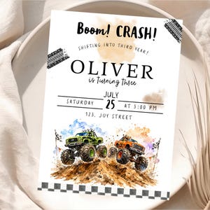 May include: A birthday invitation with the text "Boom! CRASH!" and "OLIVER is turning three." The invitation features watercolor illustrations of green and orange monster trucks racing over a dirt hill. The date is July 25th.