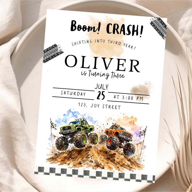 May include: A birthday invitation with the text "Boom! CRASH!" and "OLIVER is turning three." The invitation features watercolor illustrations of green and orange monster trucks racing over a dirt hill. The date is July 25th.