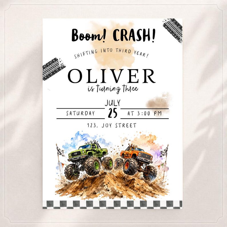 May include: White invitation card with the text "Boom! CRASH!" and "OLIVER is turning three". Features watercolor illustrations of two monster trucks on a dirt hill. Includes event details: Saturday, July 25th at 3:00 PM.