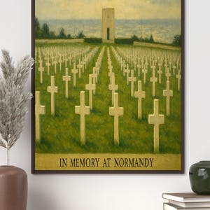 May include: A framed print showing a war cemetery with white crosses on a green field, leading to a memorial building under a cloudy sky. The text "IN MEMORY AT NORMANDY" is at the bottom.