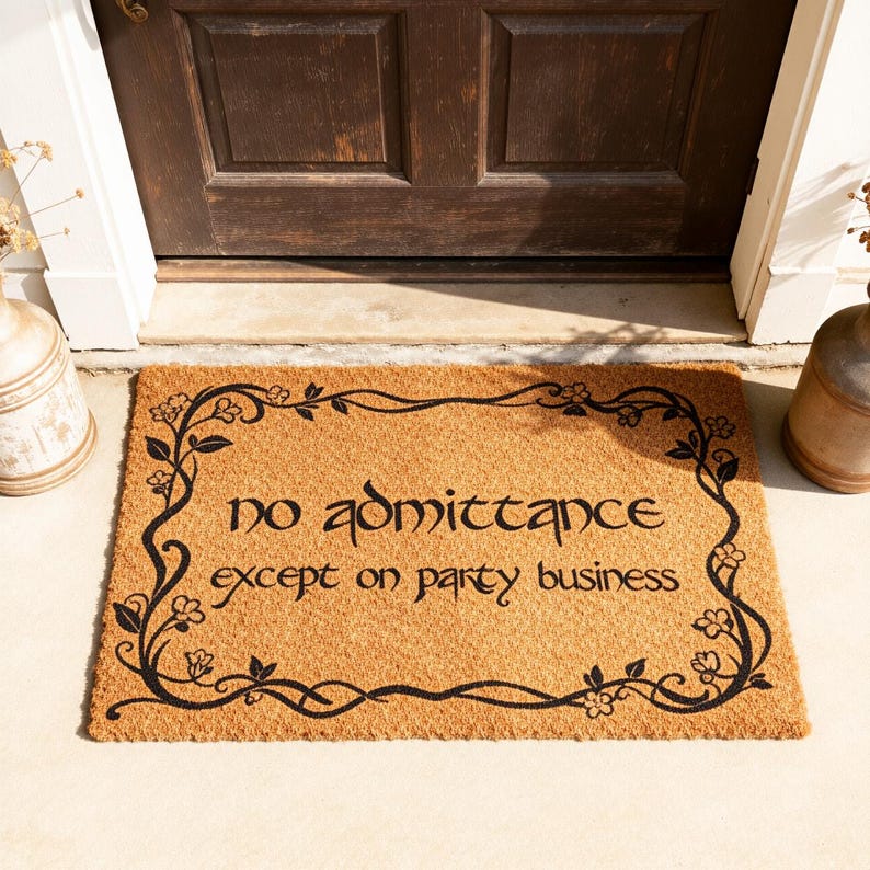 May include: A rectangular doormat made of natural coir fiber. The mat features the text "no admittance except on party business" in black script, framed by a black floral border. The mat is placed in front of a brown door.