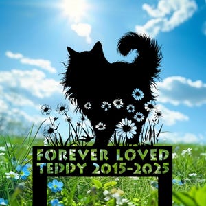 May include: Black metal pet memorial garden stake featuring a silhouette of a cat with daisy accents. The stake reads "FOREVER LOVED TEDDY 2015-2025" in green lettering, set against a backdrop of a sunny sky and green grass.