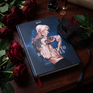 May include: A hardback book titled Bring Him To His Knees with a dark blue cover featuring an illustration of a shirtless person with tattoos, surrounded by deep red roses and a black lace masquerade mask on a dark wooden surface.