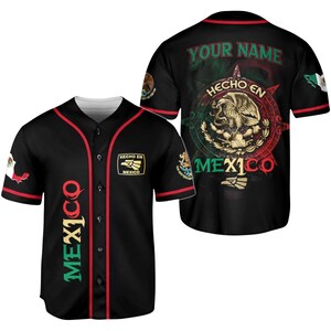 May include: Black baseball jersey with red trim and the word "MEXICO" in green, red, and yellow down the front. The back features a Mexican flag design with an eagle and the text "YOUR NAME" and "HECHO EN MEXICO".