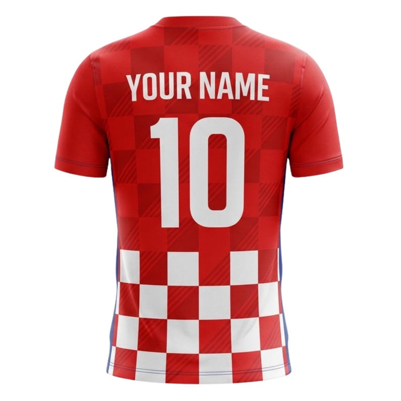 May include: Red soccer jersey with white accents and a checkered pattern. The back features the number 10 in white and the text "YOUR NAME" above it. The jersey has short sleeves and a blue stripe on the side.