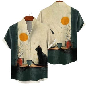 May include: Short-sleeved button-up shirt featuring an artistic design. The shirt showcases a black cat, a yellow sun, and a still-life scene with a vase and a cup. The color palette includes beige, green, and orange tones, creating a unique aesthetic.