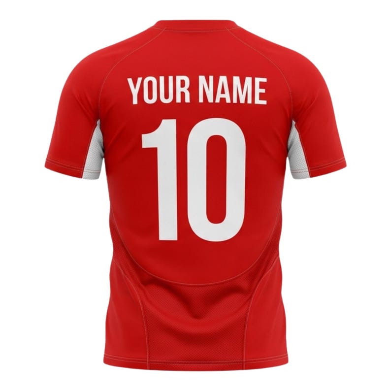 May include: Red athletic jersey with white accents on the sleeves. The back of the jersey features the text "YOUR NAME" above the number "10" in white, centered on the back.