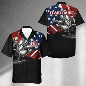 May include: Black bowling shirt with a design featuring bowling pins and a ball. The shirt has a red, white, and blue American flag design on the front and back. The text "YOUR NAME" and "TEAM NAME" are visible.