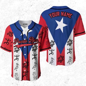 May include: A short-sleeved baseball jersey featuring the Puerto Rican flag design. The front displays the words "Puerto Rico" and various tribal symbols. The back has a blue triangle with a white star and the text "YOUR NAME". The jersey is red, white, and blue.