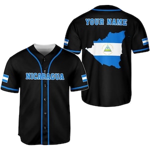 May include: Black baseball jersey with blue accents and the word "NICARAGUA" across the chest. The back features a map of Nicaragua with the national flag and the text "YOUR NAME" above it. The sleeves have a small flag design.