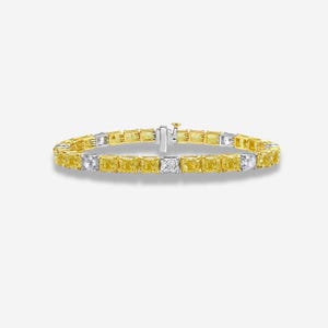 May include: A gold and silver bracelet featuring a series of yellow and white rectangular gemstones. The bracelet is secured with a clasp and is displayed against a white background. The gemstones are evenly spaced.