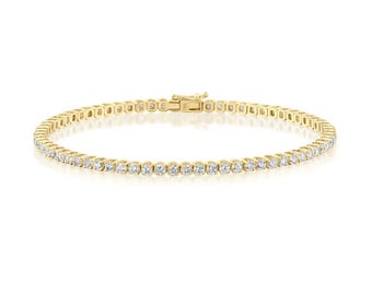 May include: A gold tennis bracelet with a row of round-cut diamonds. The bracelet is made of yellow gold and features a secure clasp. This elegant piece of jewelry is suitable for everyday wear or special occasions.