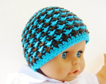 May include: A blue and brown crocheted hat with a textured pattern.