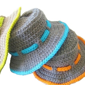 May include: Three crocheted bucket hats in different colors. The first hat is beige with a lime green trim. The second hat is gray with a turquoise trim. The third hat is gray with an orange trim.