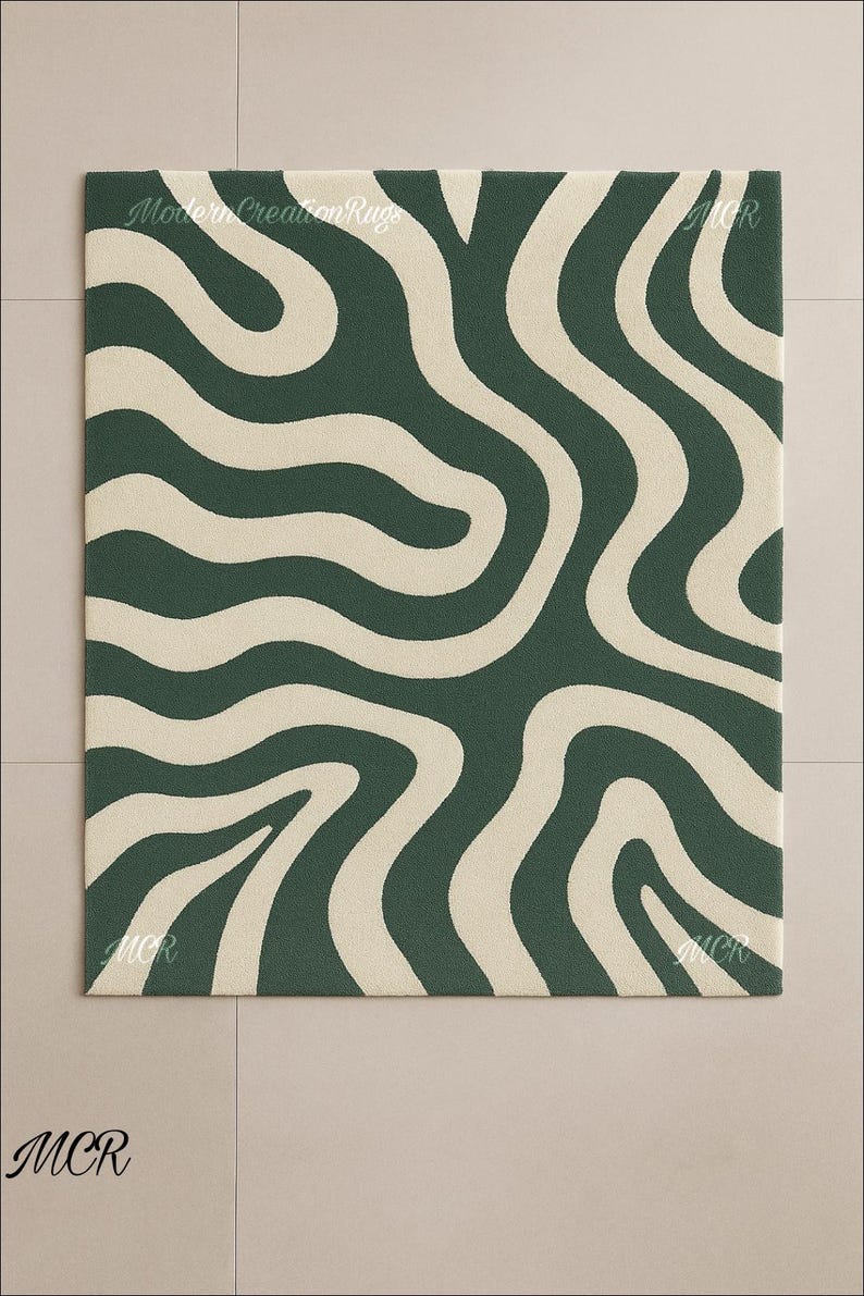 May include: A rectangular rug with a dark green background and a cream-colored, wavy pattern. The rug has the text "Modern Creation Rugs" and "MCR" in the corners. The rug is on a light beige tiled floor.