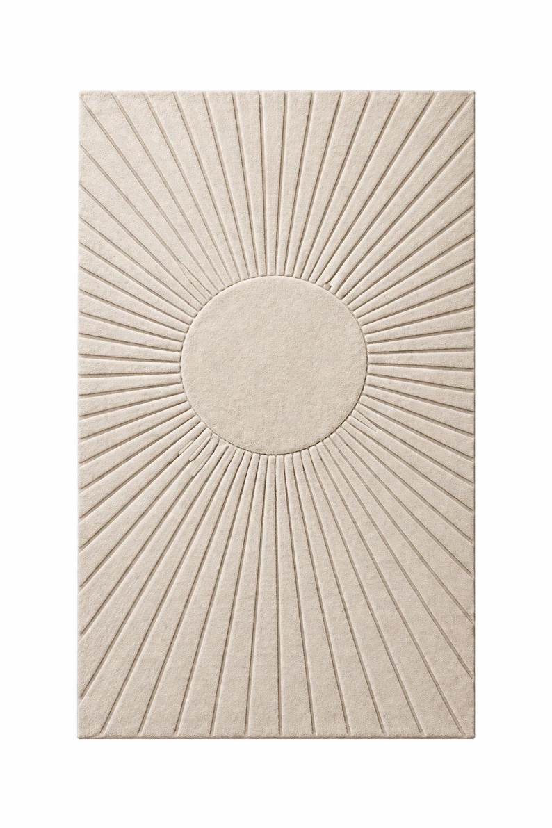 May include: Beige rectangular rug with a sunburst design. The rug features a central circular element with radiating lines, creating a textured, three-dimensional effect. The neutral color palette makes it suitable for various interior styles.