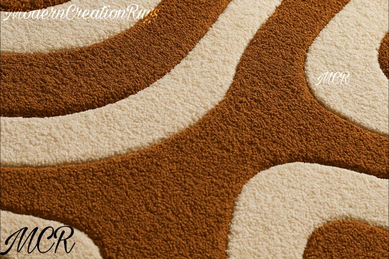 May include: Close-up of a textured rug with a retro design. The rug features a pattern of flowing, curved lines in shades of brown and cream. The letters "MCR" are visible in the corners, and "modernCreationRugs" is at the top.