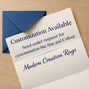 May include: A navy blue envelope rests beside a folded paper with the text "Customization Available" and "Modern Creation Rugs". The paper also states to send an order request for customization like size and color.