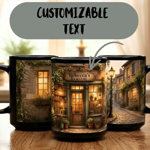 May include: Black ceramic mug with a detailed illustration of a bookstore facade, featuring the text "Rebecca's Bookstore". The design includes a cobblestone street and warm lighting, with the words "Customizable Text" above.