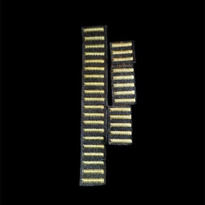 May include: Three black fabric patches with gold horizontal stripes. The patches are arranged in a vertical and angled configuration against a black background. The gold stripes are evenly spaced.