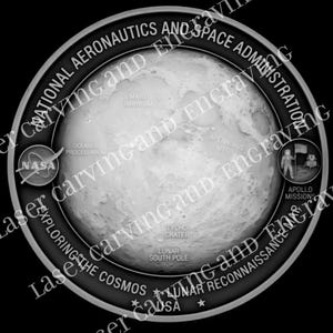 May include: A monochrome circular emblem showing a detailed lunar surface with labeled features. The NASA logo is present, alongside text reading "NATIONAL AERONAUTICS AND SPACE ADMINISTRATION" and "APOLLO MISSIONS".