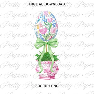 May include: Watercolor illustration of an Easter egg topiary. The egg is decorated with pink flowers and blue leaves. It is tied with a green bow and sits in a pink and white patterned pot. The text "DIGITAL DOWNLOAD" and "300 DPI PNG" are visible.