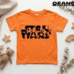 May include: A white ceramic mug with a black handle and the text "But First, Coffee" in a black, bold font. The mug is sitting on a wooden surface.