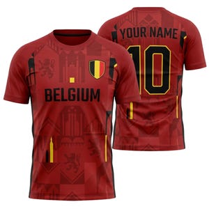 Op de afbeelding: Rood en zwart België voetbalshirt met het woord "BELGIUM" over de borst. Het shirt heeft nummer 10 op de rug met de optie om een naam toe te voegen. Het shirt heeft een geometrisch patroon en de Belgische vlag.