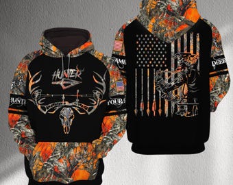 Moletom com capuz camuflado para caçador com arco, com chifres de crânio de veado e bandeira dos EUA, estampa de floresta laranja, ideal para caça com arco e flecha, unissex, ótima opção de presente.