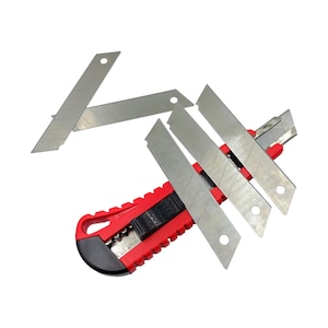 May include: A red utility knife with a black handle and several silver replacement blades. The blades are rectangular with a hole at one end. The knife is designed for cutting various materials.