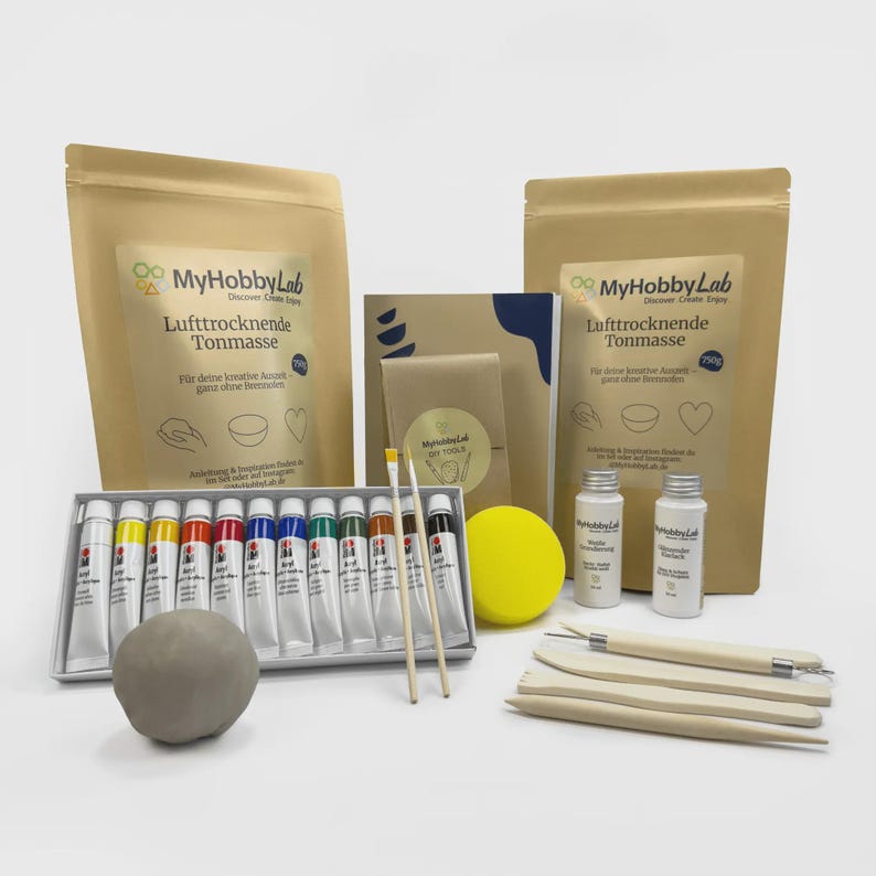 May include: A craft kit with air-dry clay, paint tubes, brushes, and sculpting tools. The kit includes two bags of clay, paint tubes in various colors, two small bottles, a yellow sponge, and wooden tools.