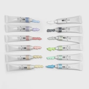 May include: An assortment of twelve tubes of acrylic paint, each with a different color extruded from the tip. The paint colors include shades of blue, purple, pink, red, white, gray, green, yellow, and beige. The tubes are white with black text.
