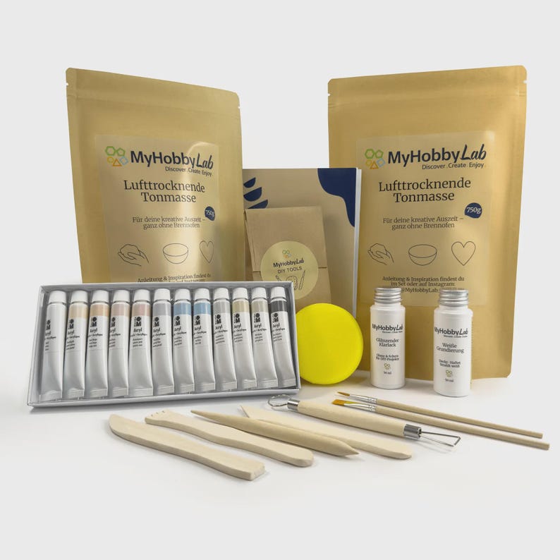 May include: A craft kit with various art supplies. The kit includes tubes of acrylic paint, sculpting tools, paintbrushes, two bottles, a yellow sponge, and two bags of air-drying clay. The packaging features the "MyHobbyLab" logo.