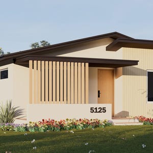 May include: A modern, single-story house with a light beige exterior, dark brown roof, and wooden accents. The house features a front porch with vertical wooden slats, a front door, and a window. The address "5125" is displayed on the front.