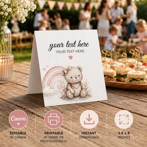 Puede incluir: Una tarjeta blanca plegada con una ilustración en acuarela de un oso de peluche beige con un lazo y pañuelo rosa, sentado frente a un arcoíris pastel y nubes. El texto dice your text here y YOUR TEXT HERE con un pequeño corazón rosa debajo.